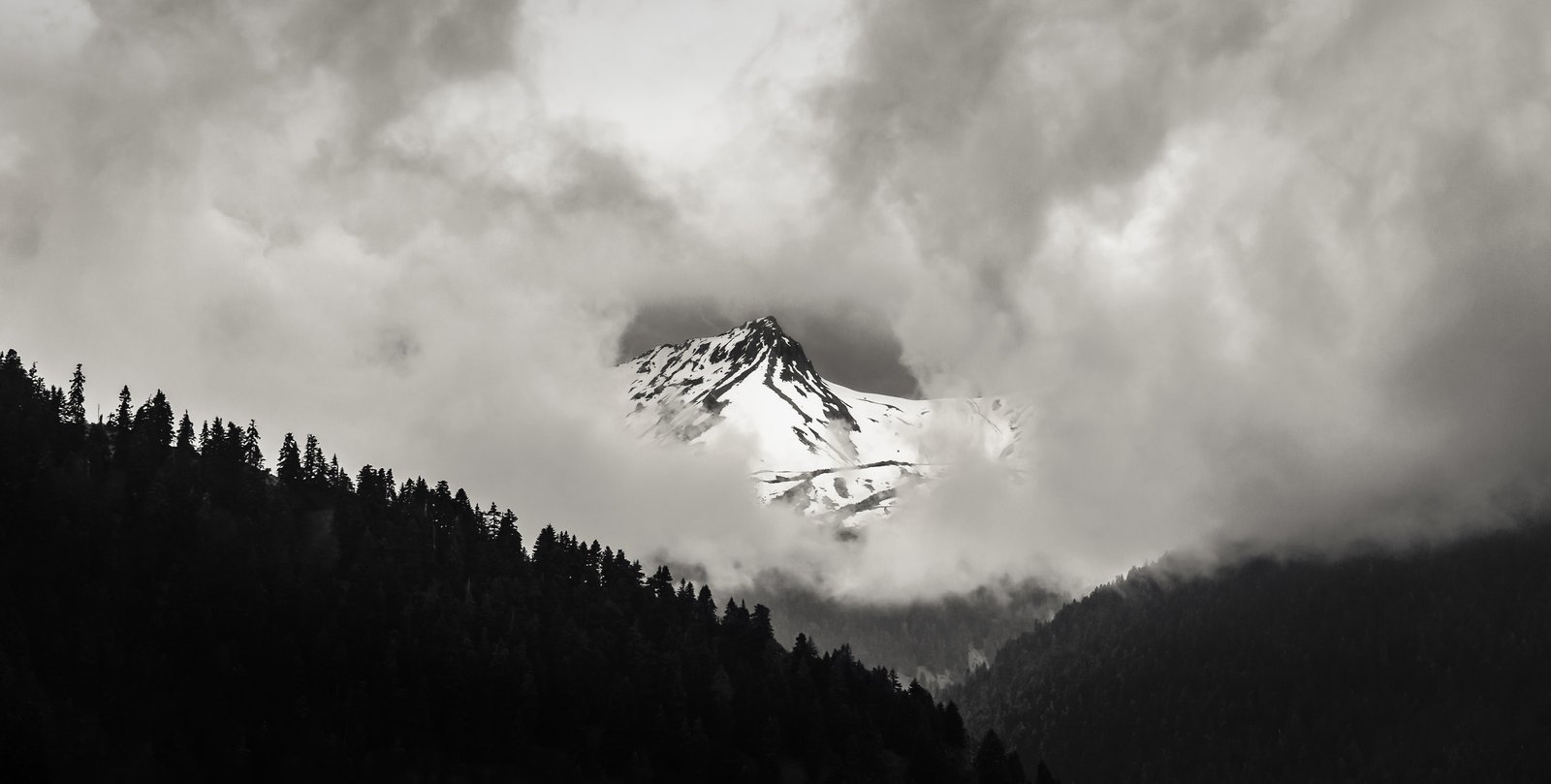 Snow-covered mountain peak partially emerging through mist – limited edition fine art photography from the Existential Forms series by Aris Dimakopoulos