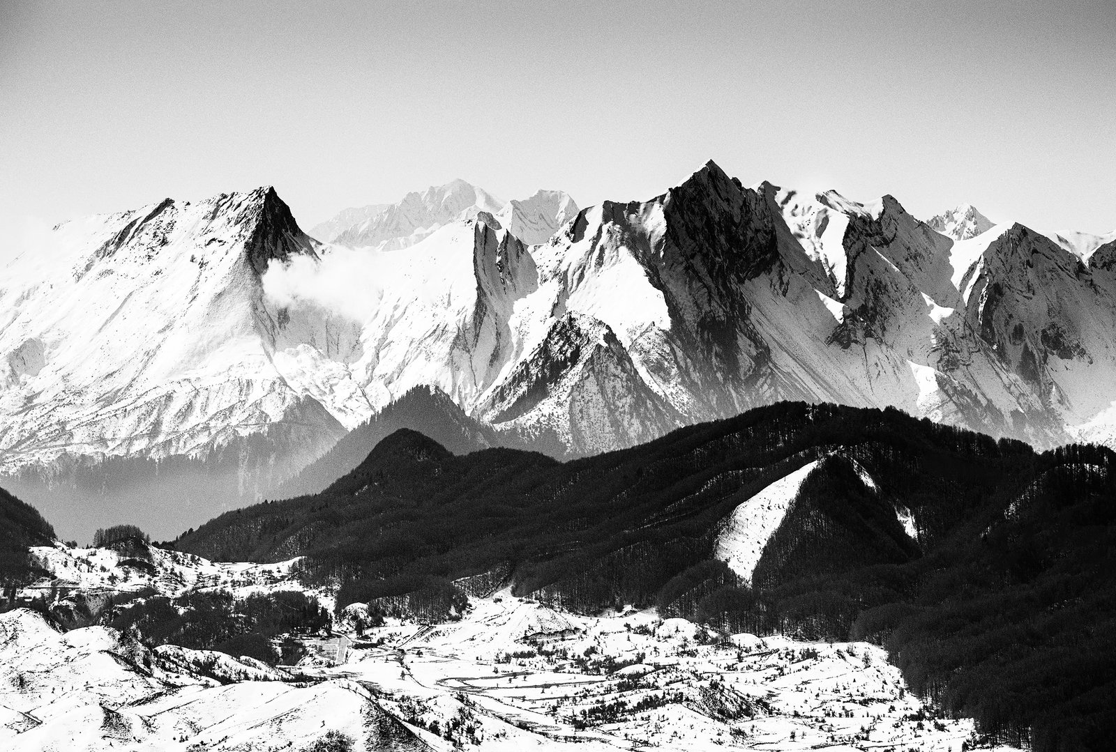 Snow covered mountain panorama rising above dark alpine forest – limited edition fine art photography from the Existential Forms series by Aris Dimakopoulos