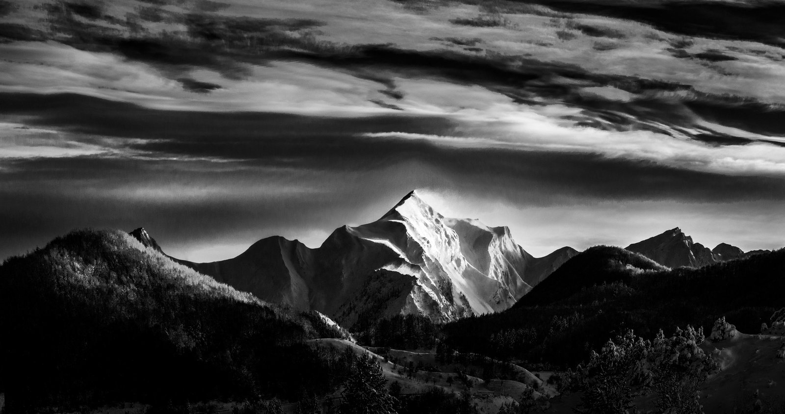 Snow-covered mountain peak fully revealed beneath layered clouds- limited edition black and white fine art photography from the Existential Forms series by Aris Dimakopoulos.